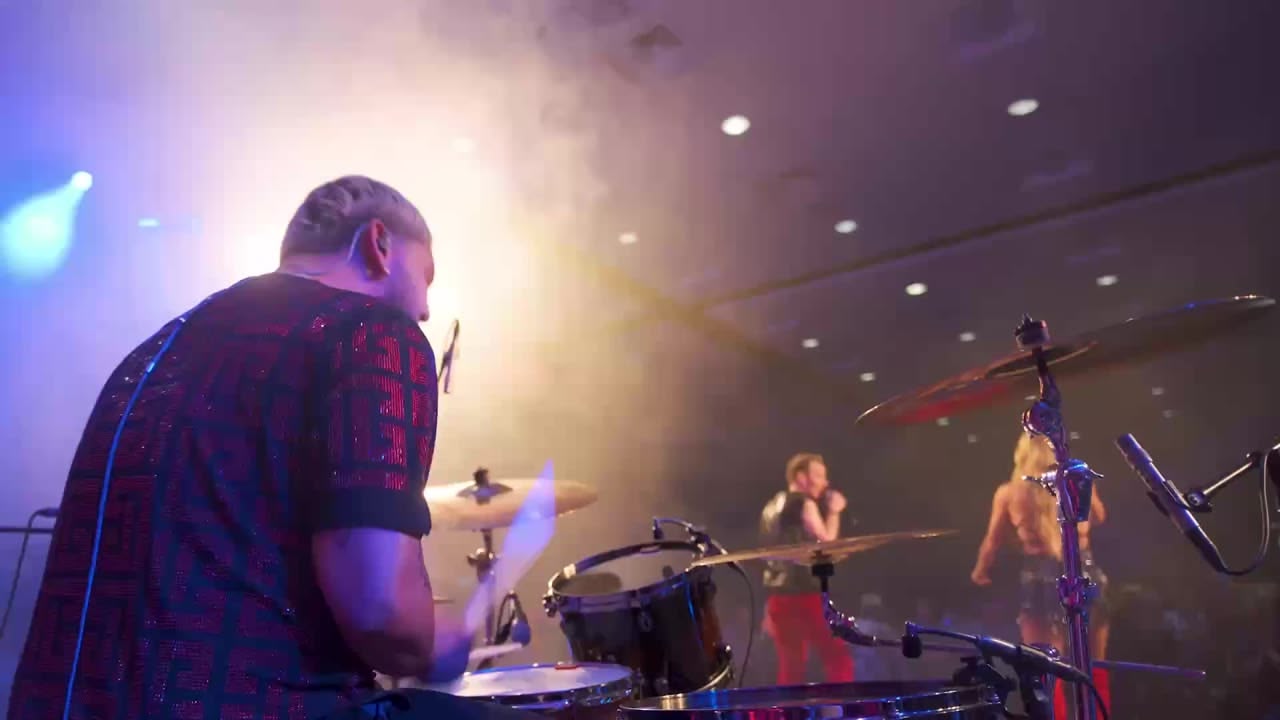 Live band drummer mid-set at the Renatus conference