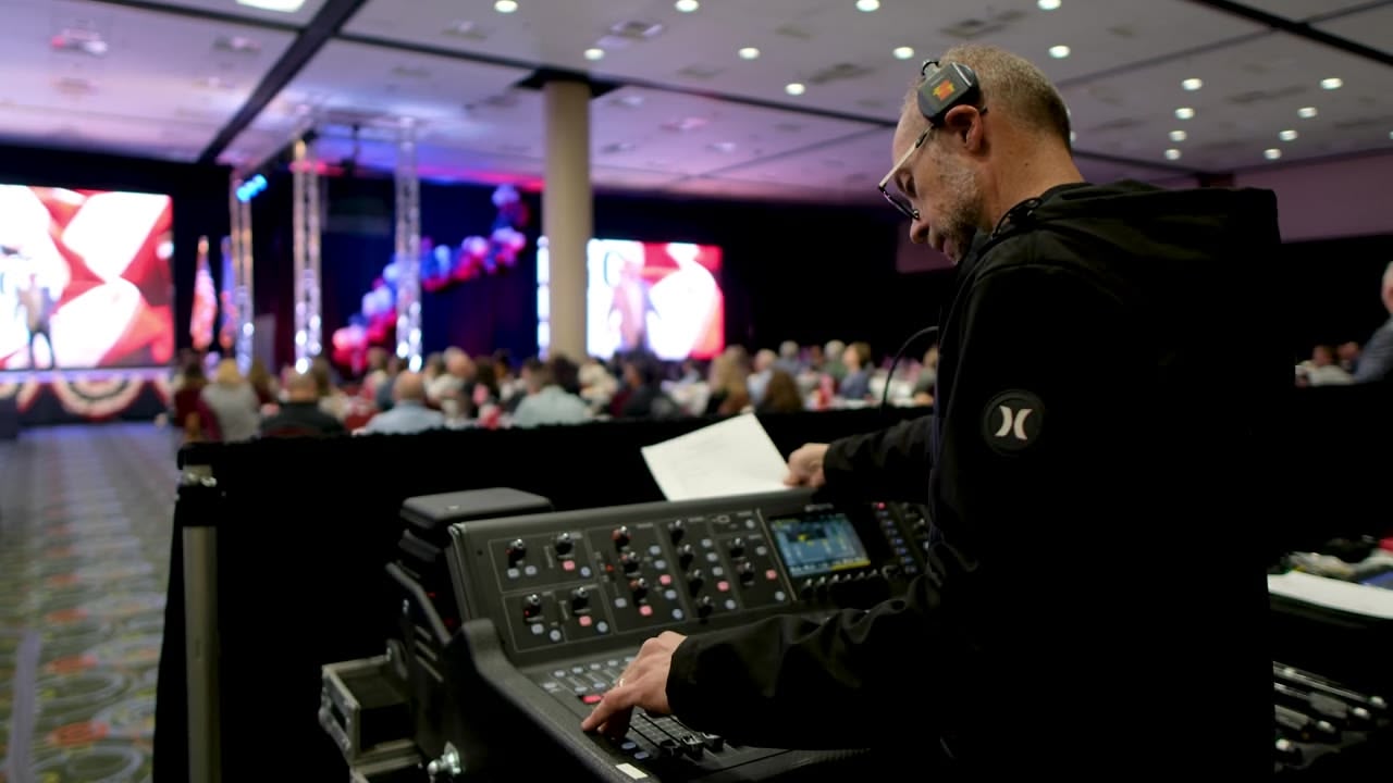 Engineer checking the run-of-show while mixing a corporate event