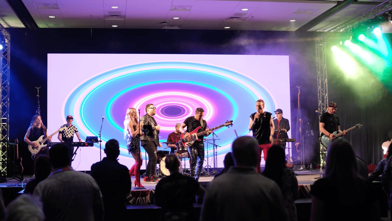 A live band on the Kellogg summit stage under colorful moving lights