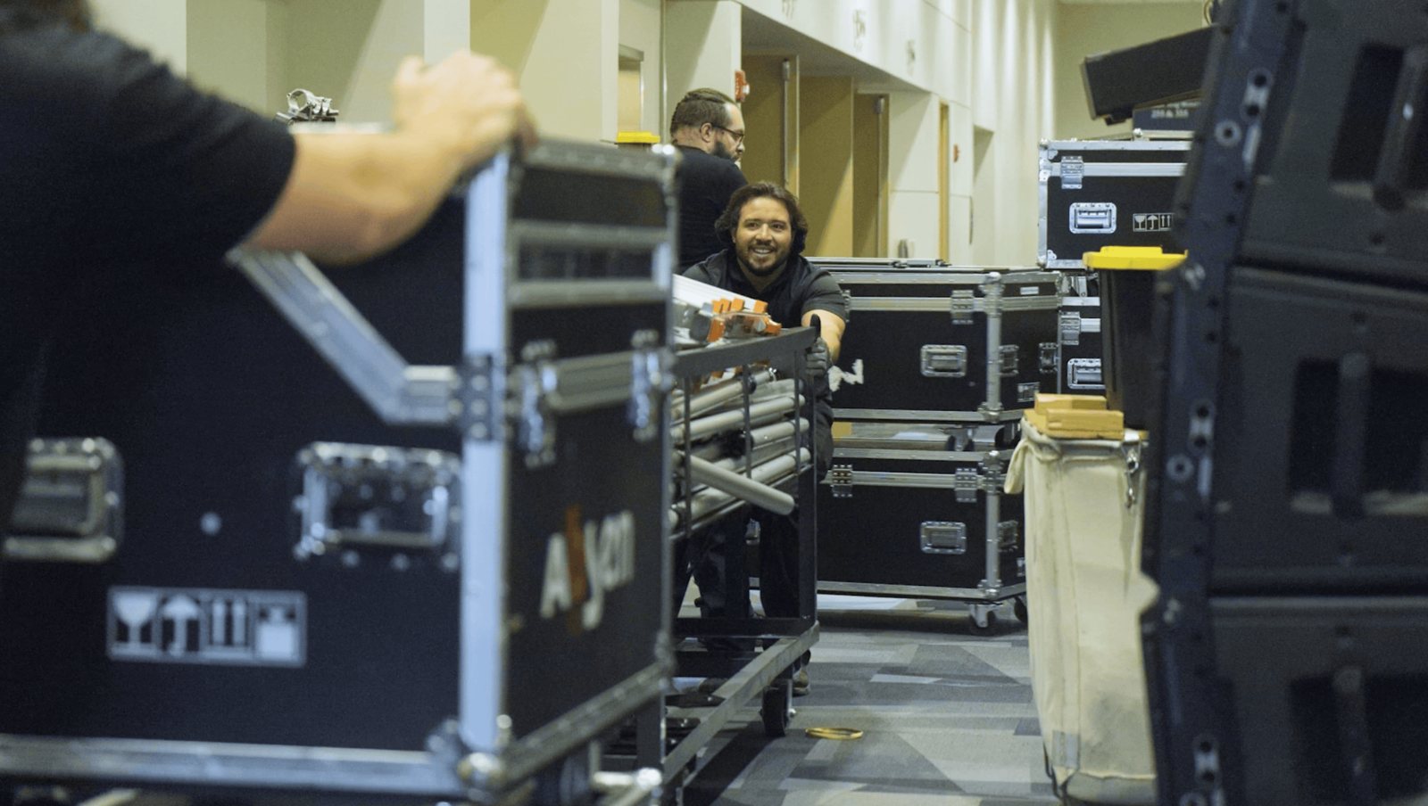 True AV crew loading in line-array speakers and road cases before an event