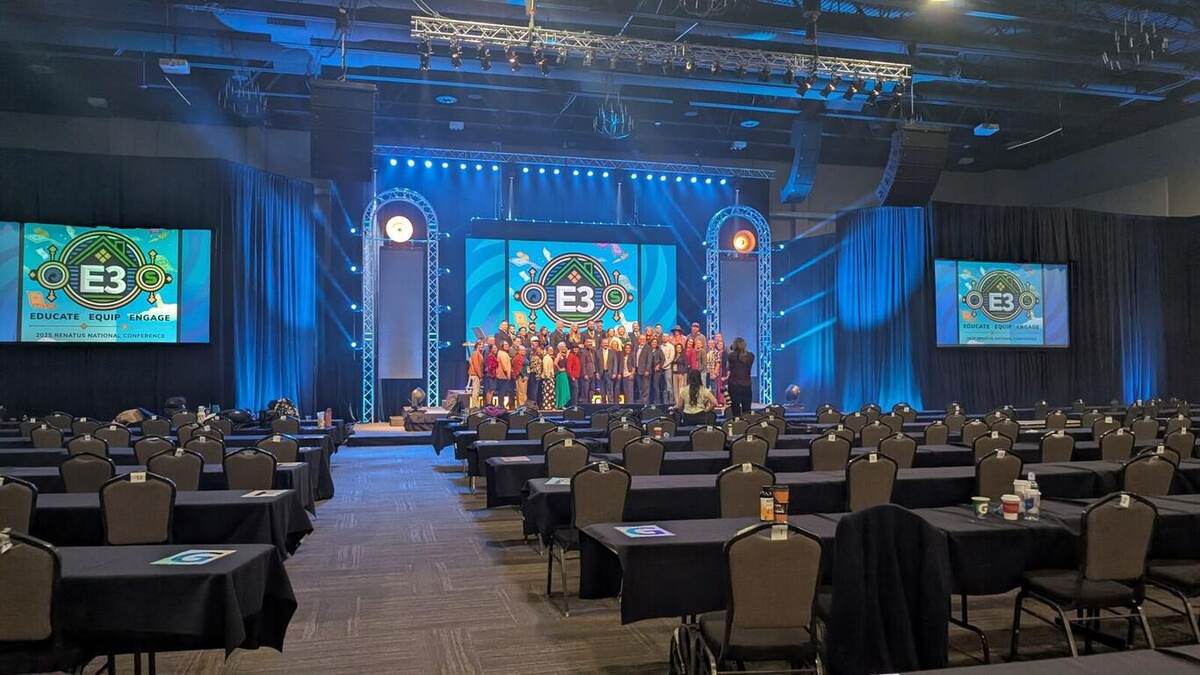 Renatus agents gathered on the three-tier stage for the all-hands group photo with E3 branding