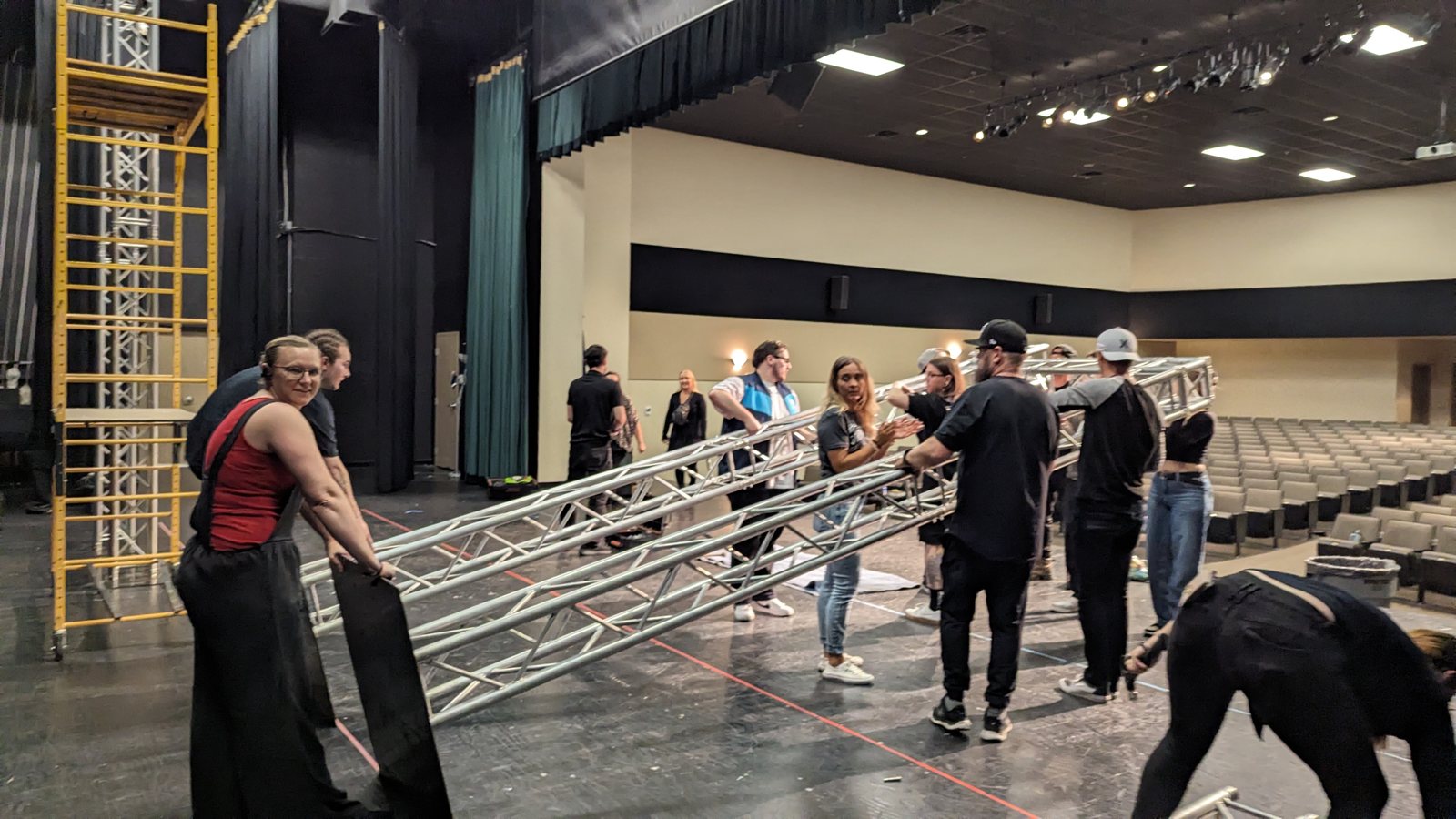 True AV crew assembling truss and staging during load-in
