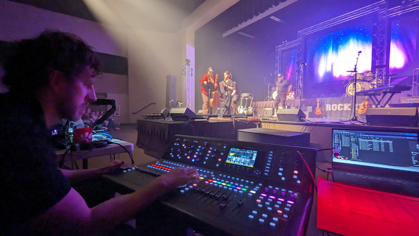 True AV engineer running the show from the front-of-house console