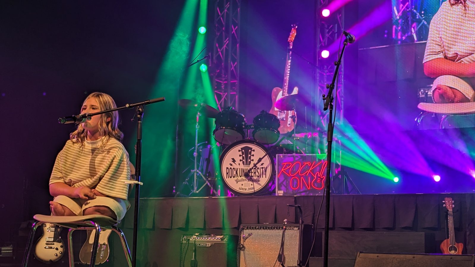 A solo student performer in dramatic concert lighting