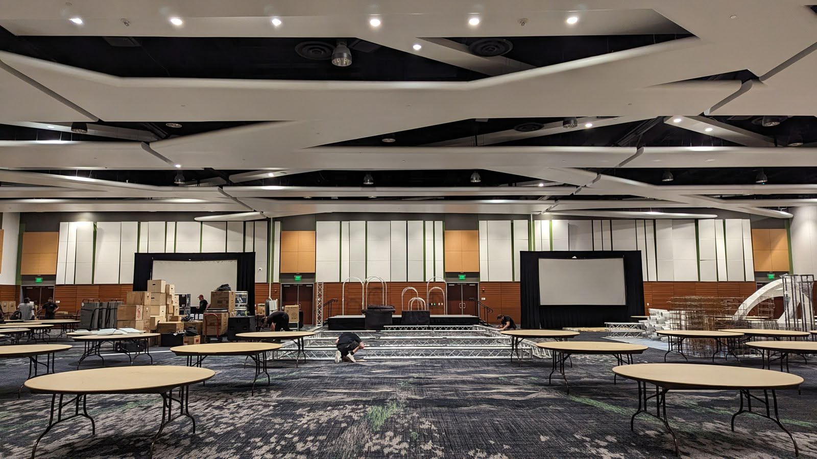 A plain convention hall during setup, before the wedding transformation