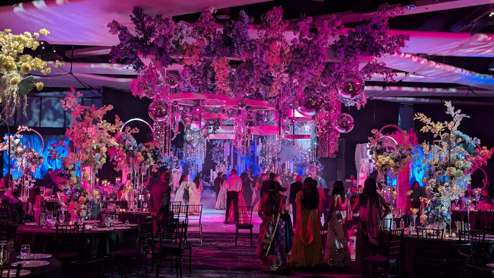 A grand ballroom bathed in pink uplighting for a formal evening
